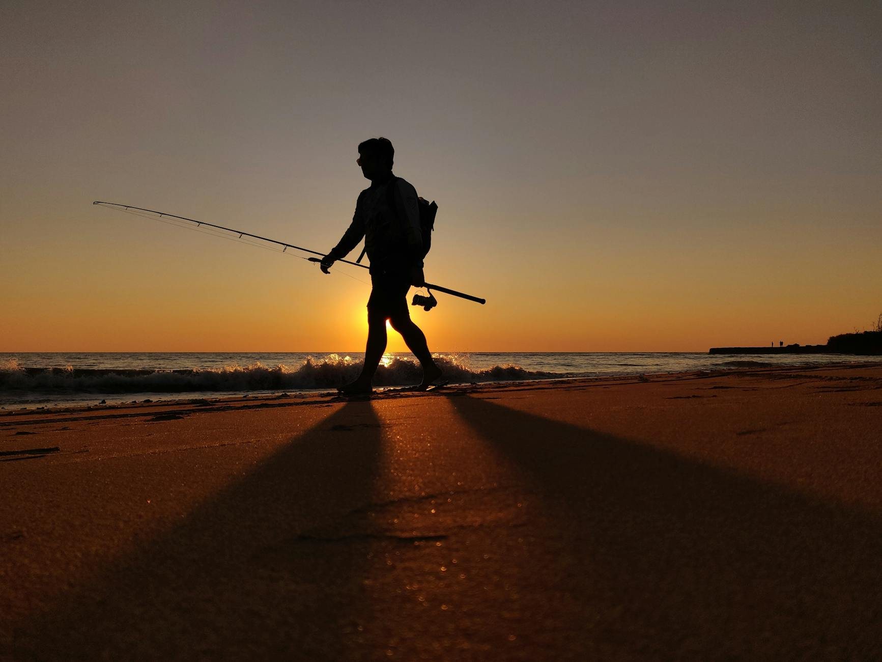 Angler preparing lures and tackle at fishing shop before coastal session